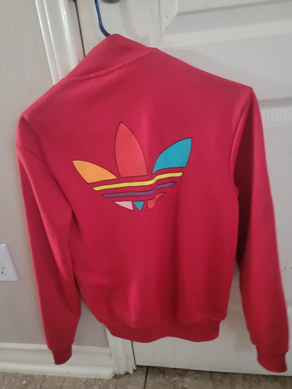 Red Adidas x Pharrell Williams track jacket